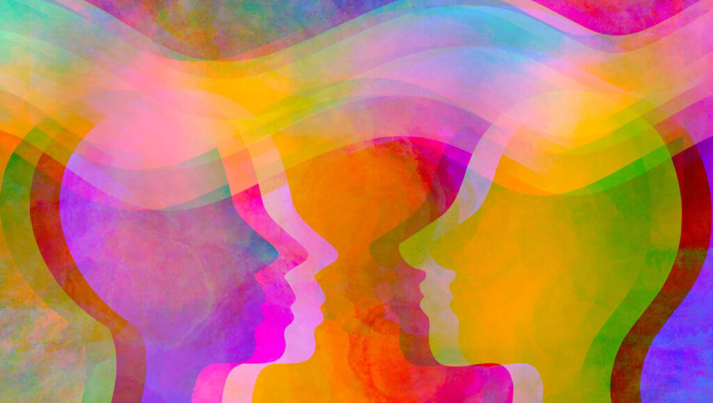 Colorful images of two human heads looking at each other inferring Emotion.